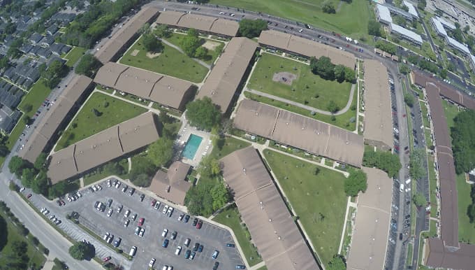 Aerial view of Willow Heights: the condominium buildings around grassy courtyards and the pool
